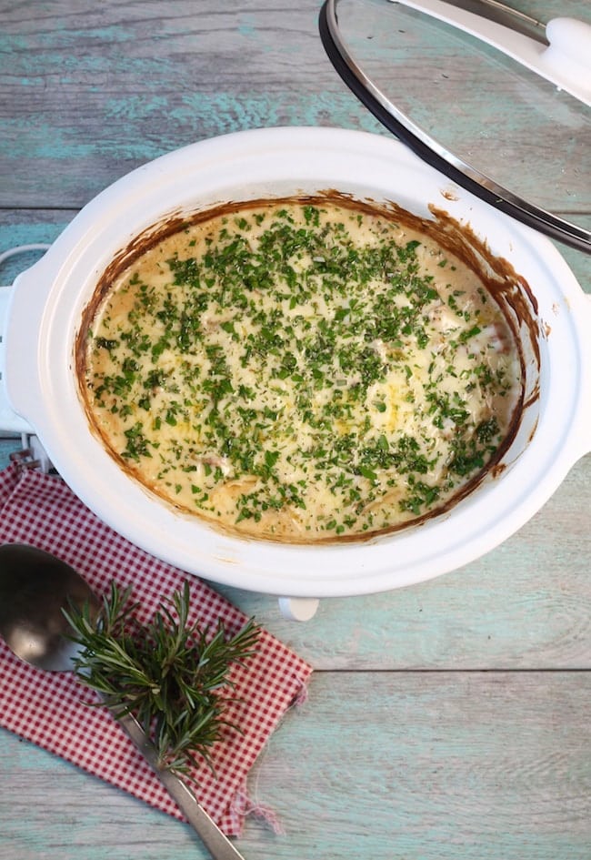 Slow Cooker Cheesy Ham and Potato Casserole topped with herbs