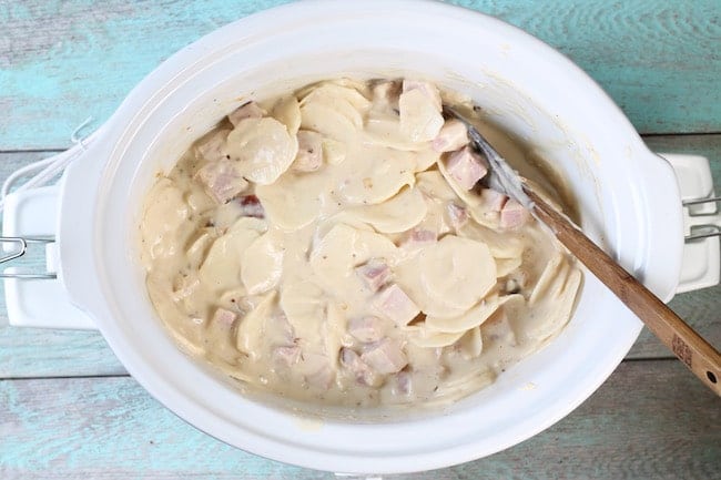 Sliced potatoes and ham in slow cooker