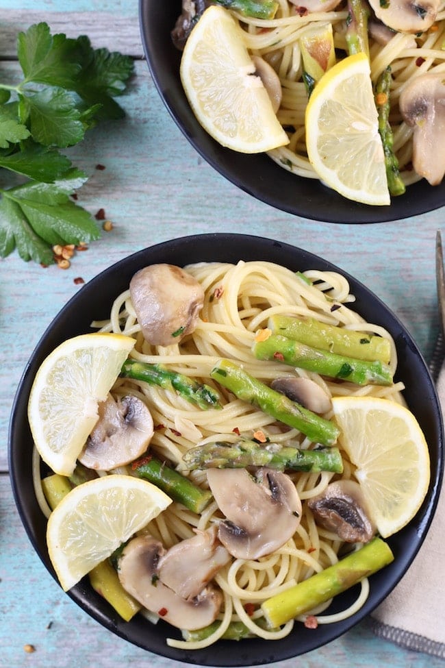 Lemon Parsley Angel Hair with Asparagus and Mushrooms garnished with fresh lemons