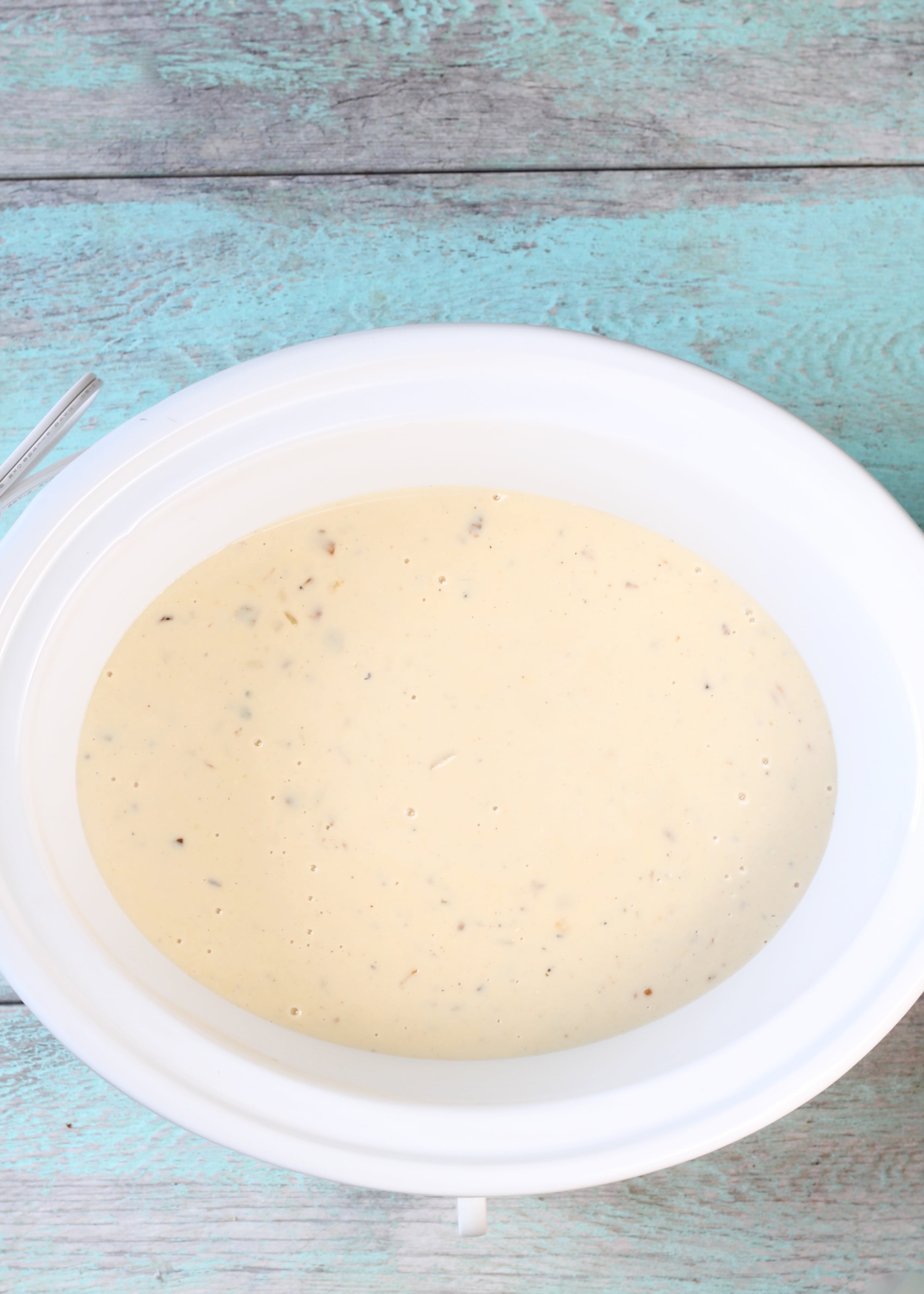 Slow cooker with cheesy sauce for ham and potato casserole
