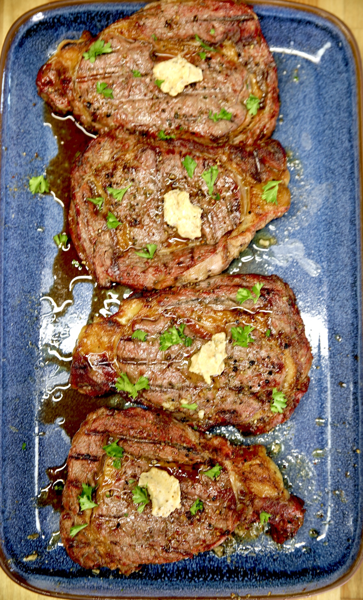 4 Ribeye steaks with garlic butter.