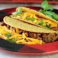 Brisket Tacos on a red palte.