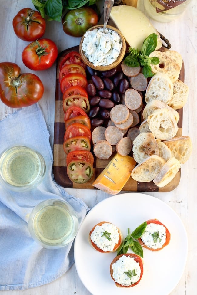 Charcuterie Board with cheddar blue cheese, smoked sausage, heirloom tomatoes, herbed ricotta and toasted baguettes