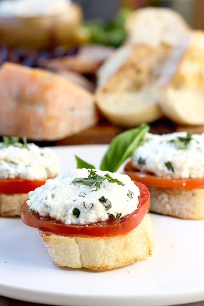 Fresh Tomato and Herbed Ricotta Bruschetta with fresh basil and rosemary