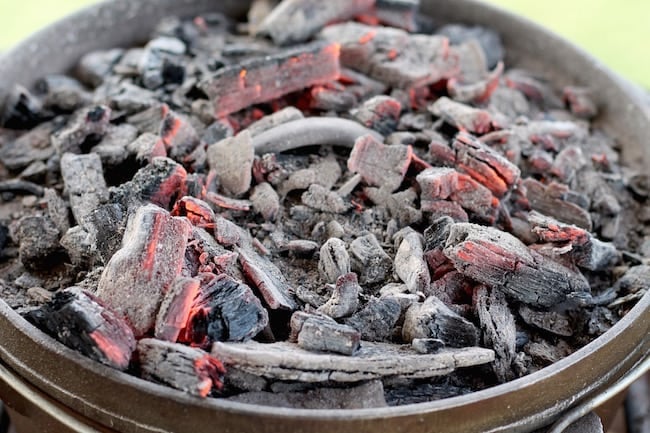 Topping the Dutch Oven with Coals for Short Ribs and potatoes campfire meal