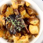 Plated Dutch Oven Short Ribs with Potatoes and Onions slow cooked over a campfire