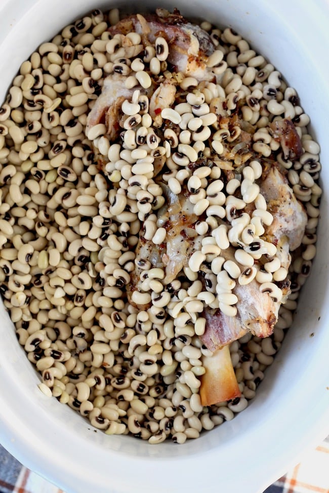 Crock Pot Southern Black Eyed Peas with bacon, onions, garlic, smoked turkey and simmered with a ham bone