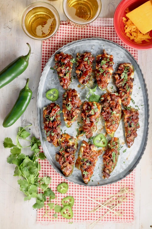 Jalapeño Poppers with Brisket and Bacon and barbecue sauce garnished with cilantro