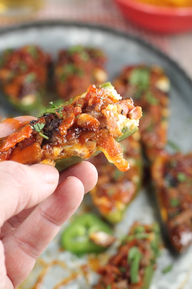 Jalapeno Poppers with Brisket and Bacon and drizzled with barbecue sauce