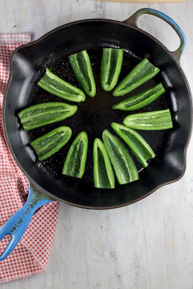 Roasting jalapeños in a skillet for jalapeno poppers