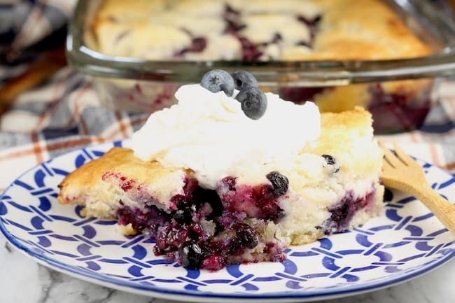 Easy Blueberry Cobbler served with sweetened whipped cream