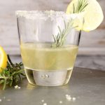 Sidecar Cocktail with bourbon served in an old fashioned glass, sugared rim, fresh rosemary and lemon garnish