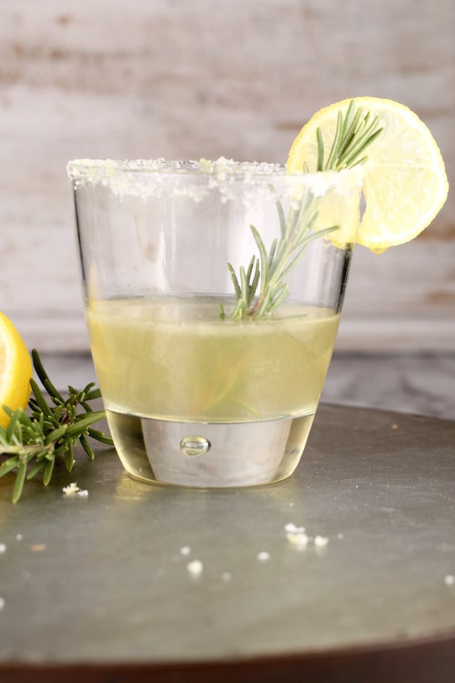 Sidecar Cocktail with bourbon served in an old fashioned glass, sugared rim, fresh rosemary and lemon garnish