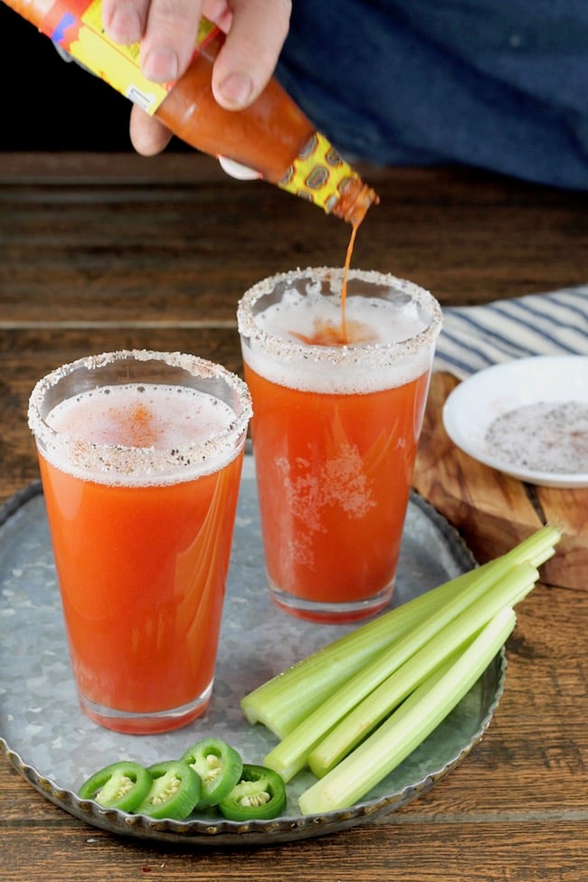 Making Spicy Red Beer Cocktails with hot sauce