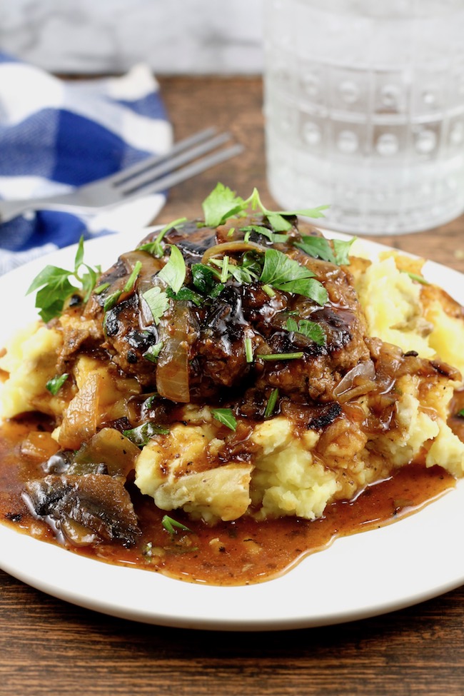 Easy Salisbury Steak with Onion and Mushroom Gravy over mashed potatoes. 