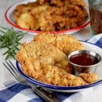 Chicken strips on a plate.