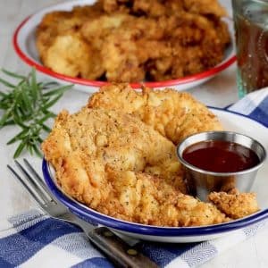 Chicken strips on a plate.