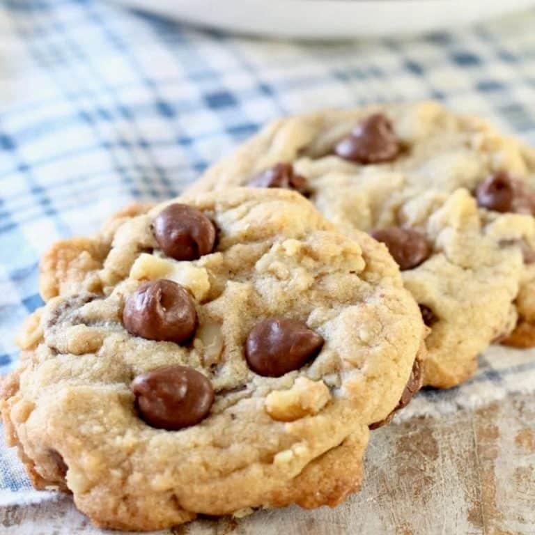 2 chocolate chip walnut cookies on a napkin.