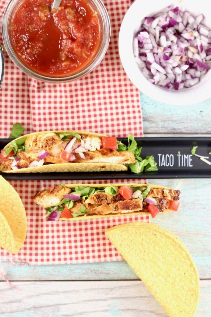 Blackened Chicken Tacos with salsa and red onions 