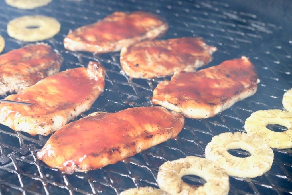 Grilled BBQ Pork Chops coated in sweet barbecue sauce and topped with grilled pineapple