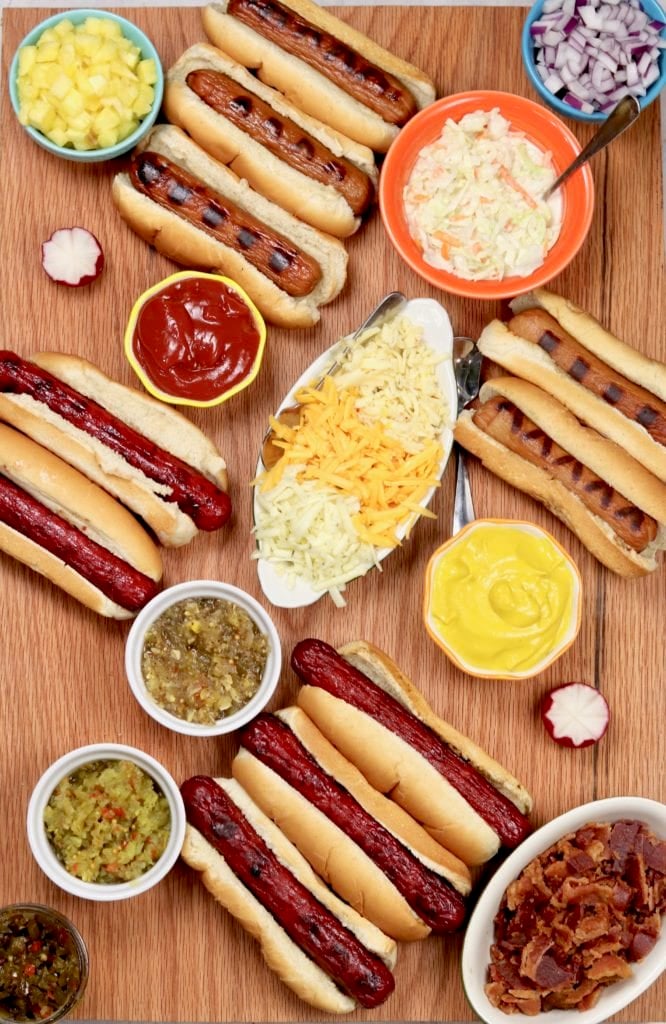 Grilled Hot Dogs with relish, bacon, mustard, slaw, and pineapples