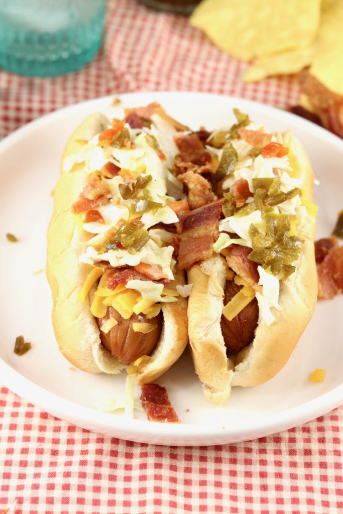  Loaded Slaw Dogs are a great addition to your summer cook out menus! Grilled hot dogs topped with smoked cheddar, bacon, creamy coleslaw and candied jalapeÃ±os 