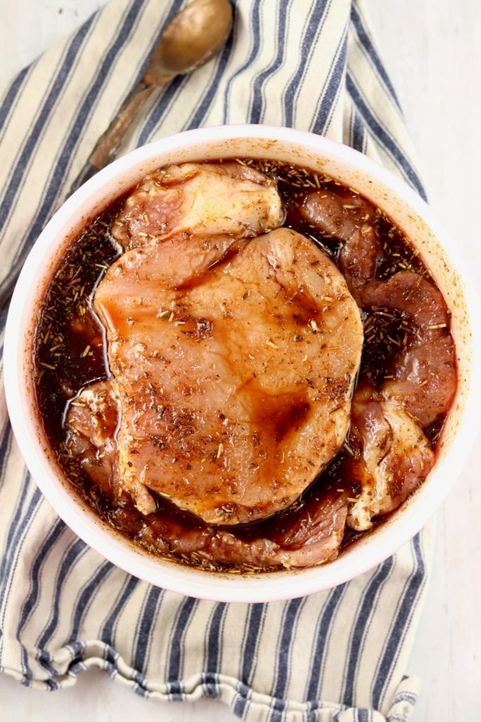 Boneless Pork Chops in a bowl with marinade