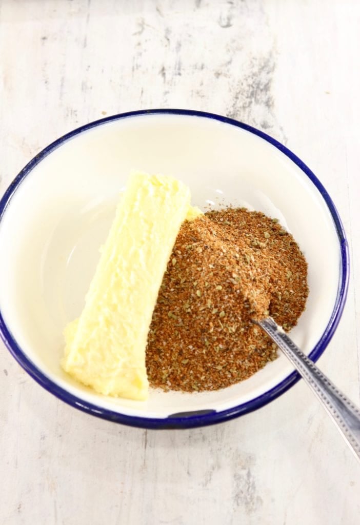 Butter and Blackened Seasoning in a blue rimmed bowl