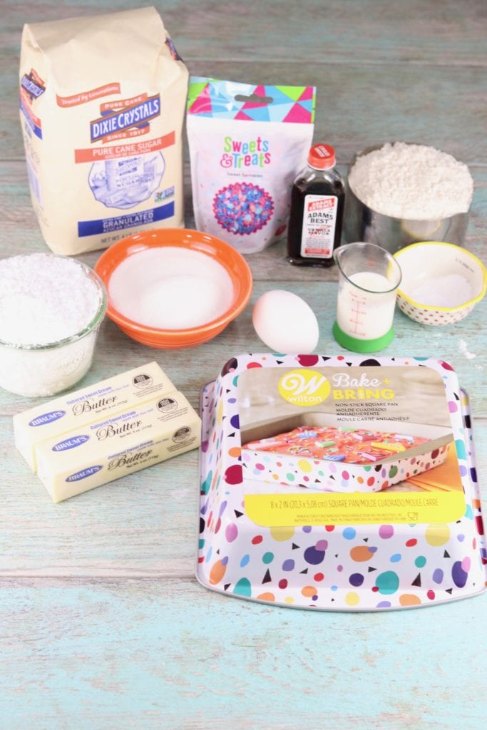 Ingredients for frosted cookie barsFrosted Cookie Bars are an easy dessert to make any day of the week or for a special occasion. A quick sugar cookie bar with buttercream icing and lots of sprinkles make a fun and simple treat!