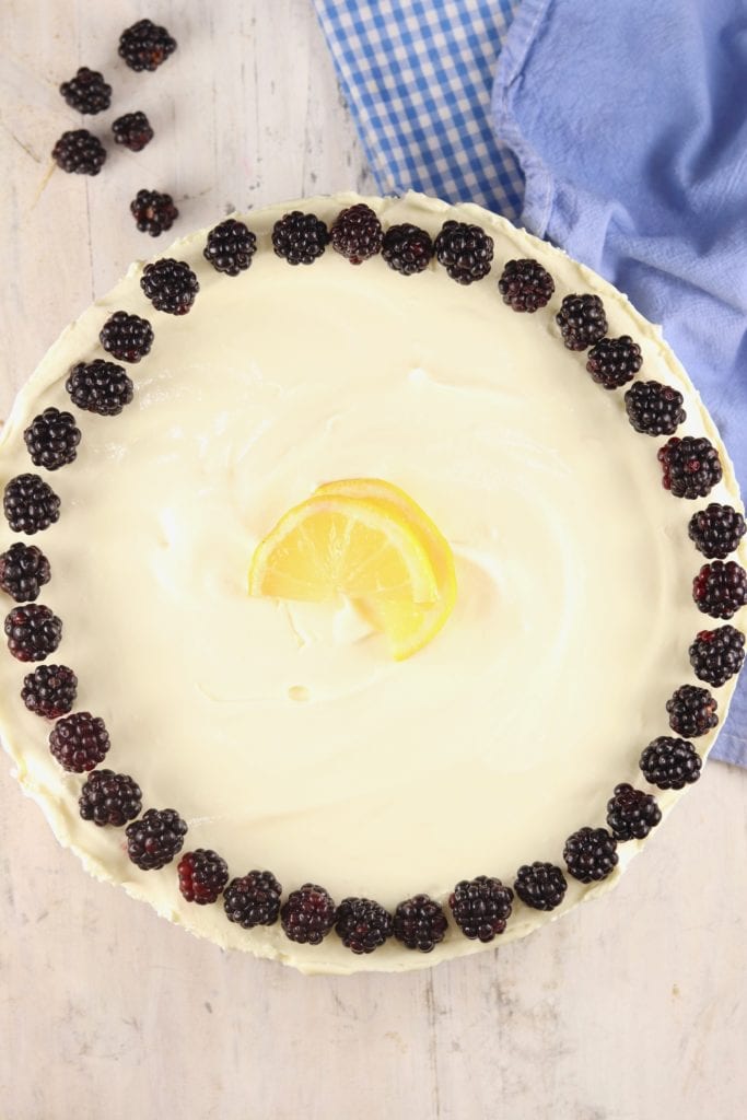 Blackberries and fresh lemons garnish a lemon chiffon pie