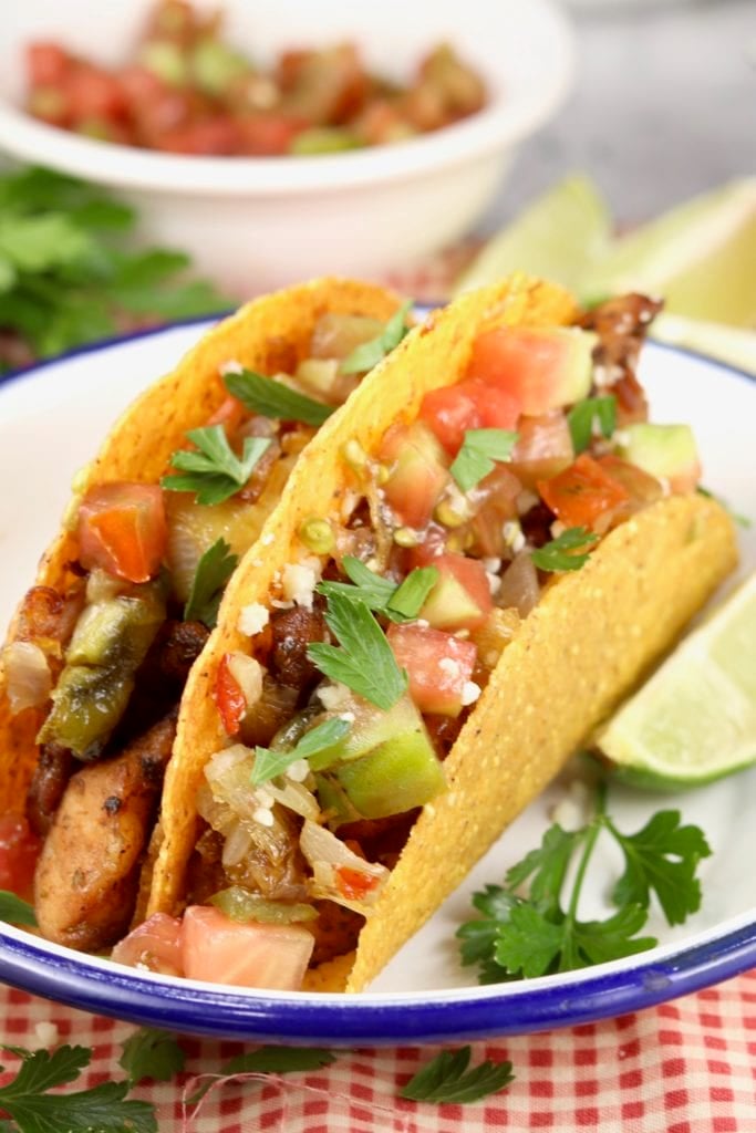 Crunchy corn tortilla tacos with fish and tomatoes