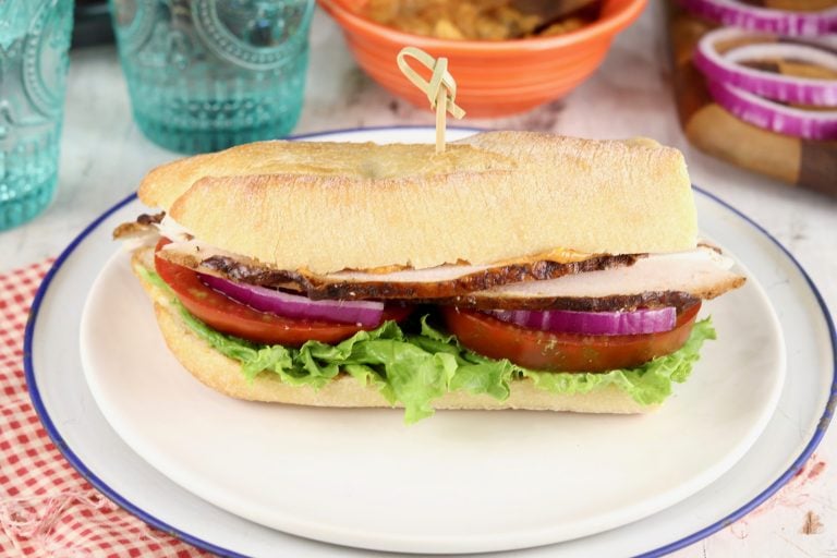 Smoked Turkey Sandwich on a baguette with tomato, lettuce and onion