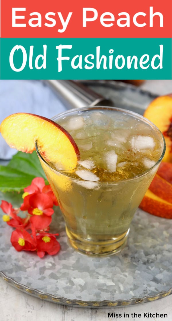 Peach old fashioned cocktail with fresh peach garnish on a tray