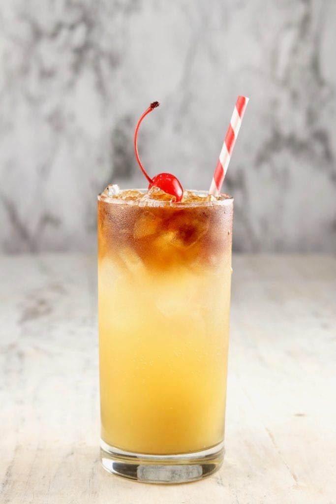 Pineapple Rum Punch with cherry and straw