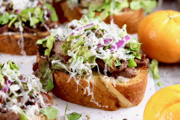 Tray of steak crostini with whole mandarin oranges
