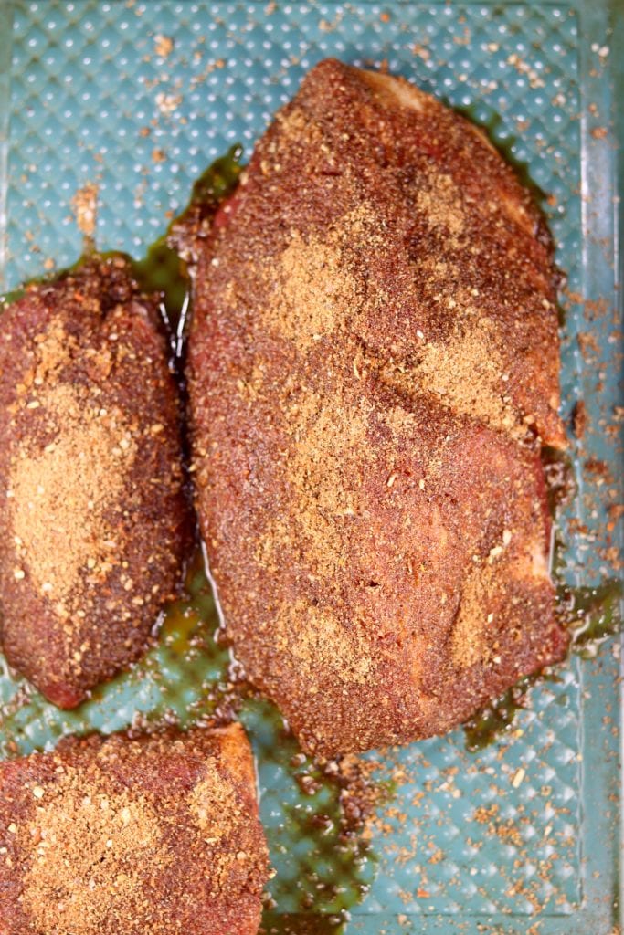 Dry Rubbed Rump Roast on a blue sheet pan
