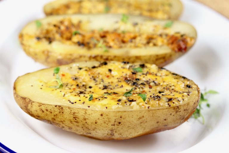 Baked potato halves with cheese and bagel seasoning