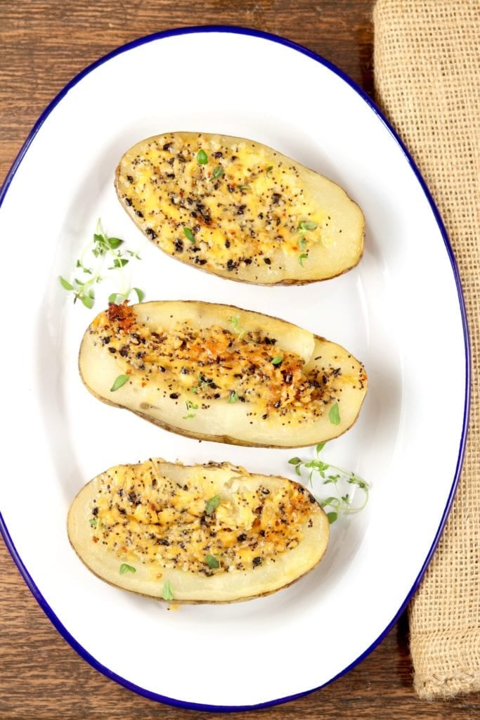 Oval tray with 3 potato halves baked with cheese