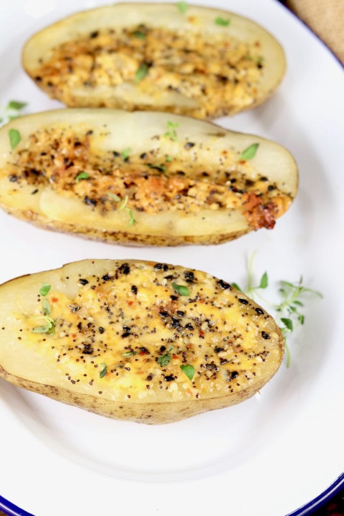 Tray of potato halves with cheese and seasonings