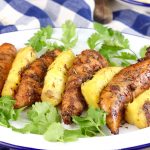 Grilled Marinated Chicken with grilled pineapple on a white plate