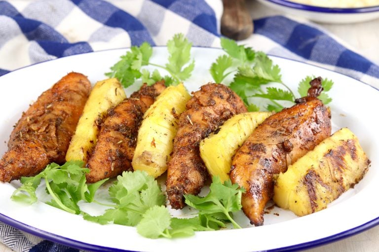Grilled Marinated Chicken with grilled pineapple on a white plate