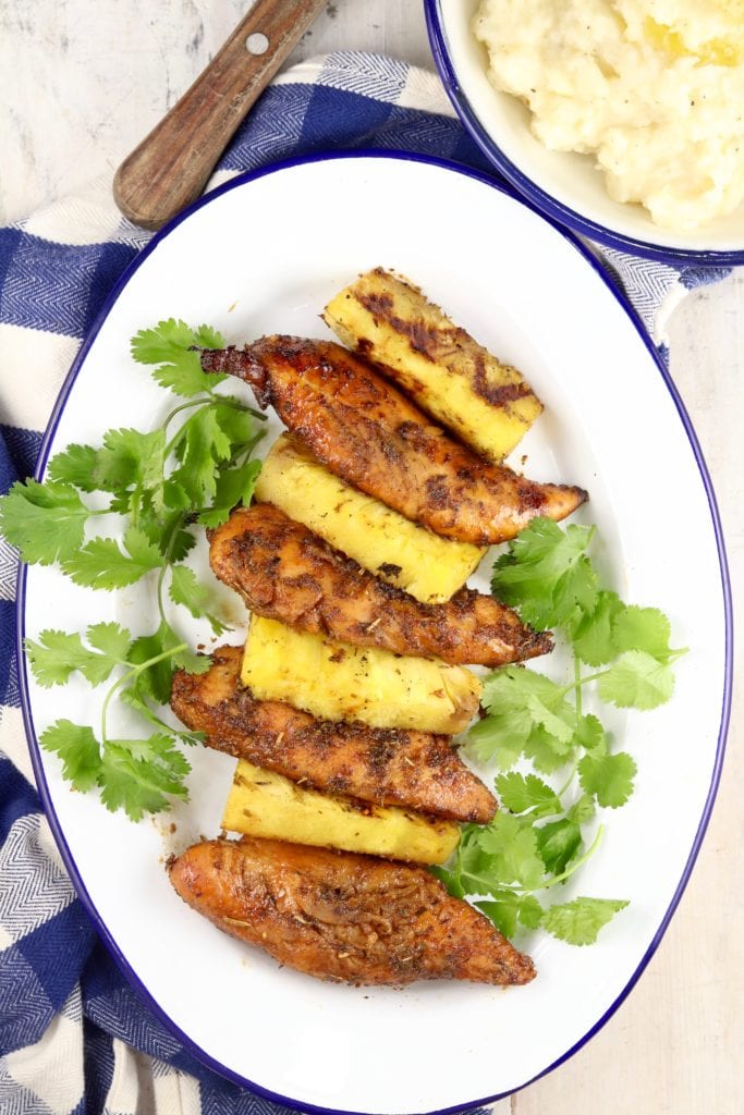 Platter of grilled chicken and pineapple with a bowl of mashed potatoes