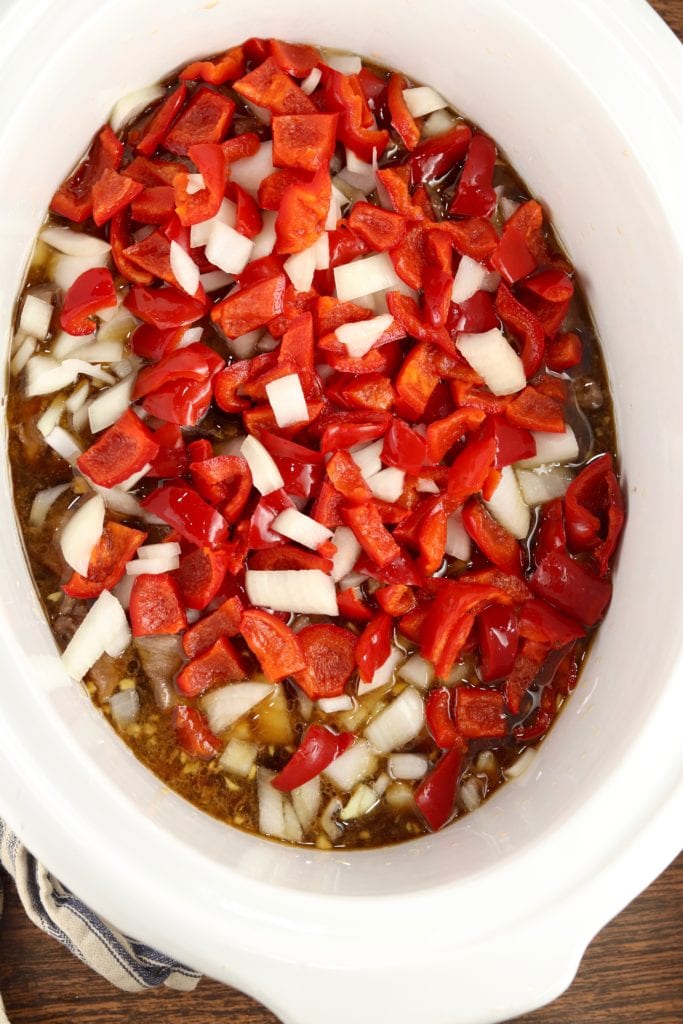 Crockpot with steak, peppers, onions