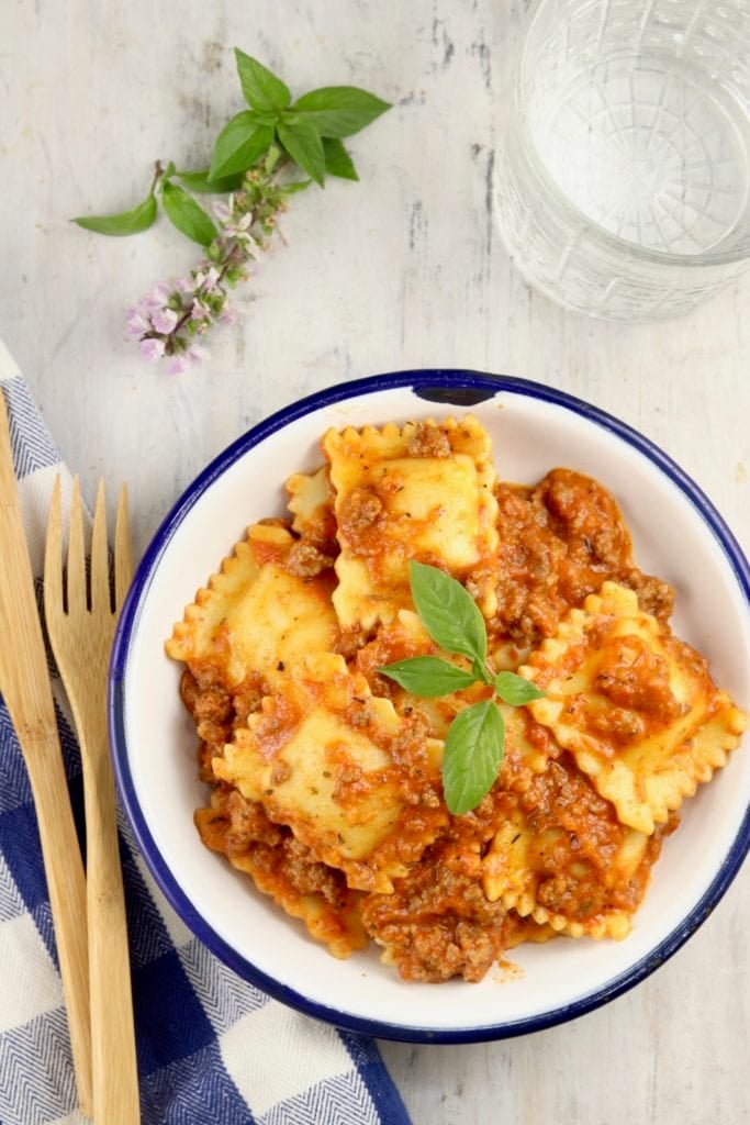 Ravioli with meat sauce in a white bowl