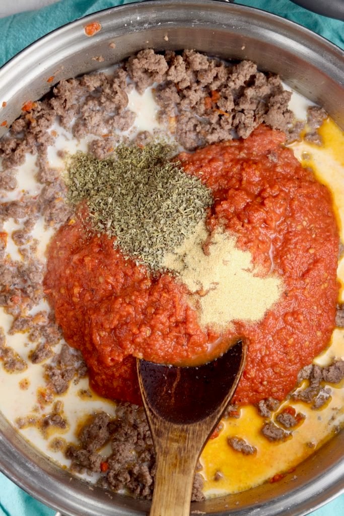 Ravioli Sauce with ground beef, tomato sauce and spices in a skillet