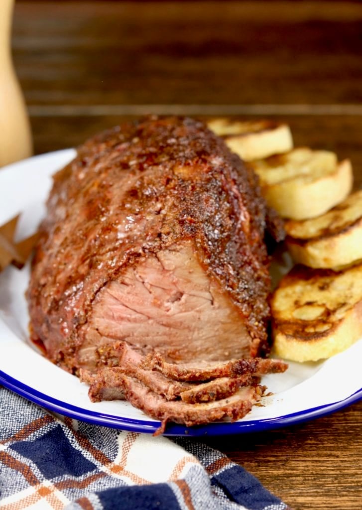 Dry rubbed roast beef grilled, sliced on a platter