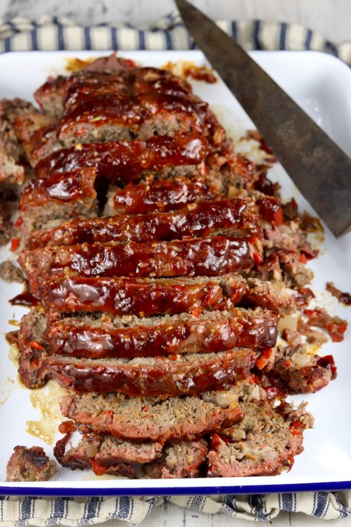 Sliced meatloaf on a white platter