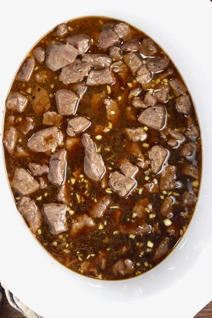 Homemade teriyaki sauce over steak tips in crock pot