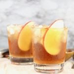 Spiked Apple Cider garnished with fresh apple slices