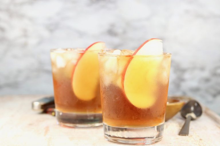 Spiked Apple Cider garnished with fresh apple slices